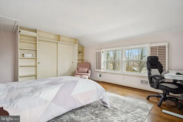 a bed room with a bed window and a chair