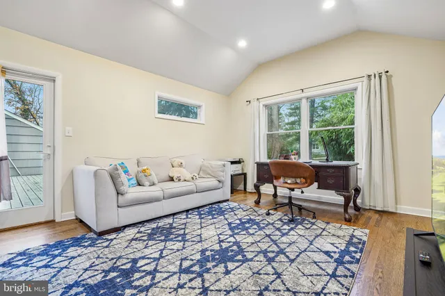 a living room with furniture and a rug