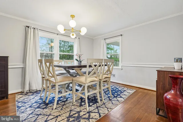 a view of an entryway with wooden floor and livingroom view