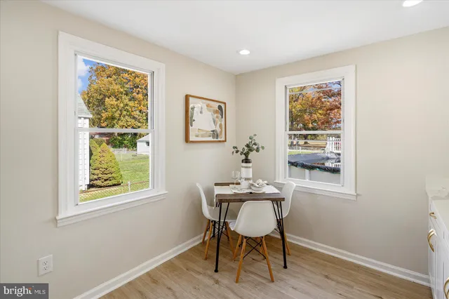 a workspace with wooden floor and a window