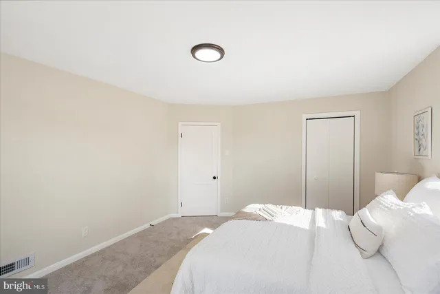 a bedroom with a bed and a night stand