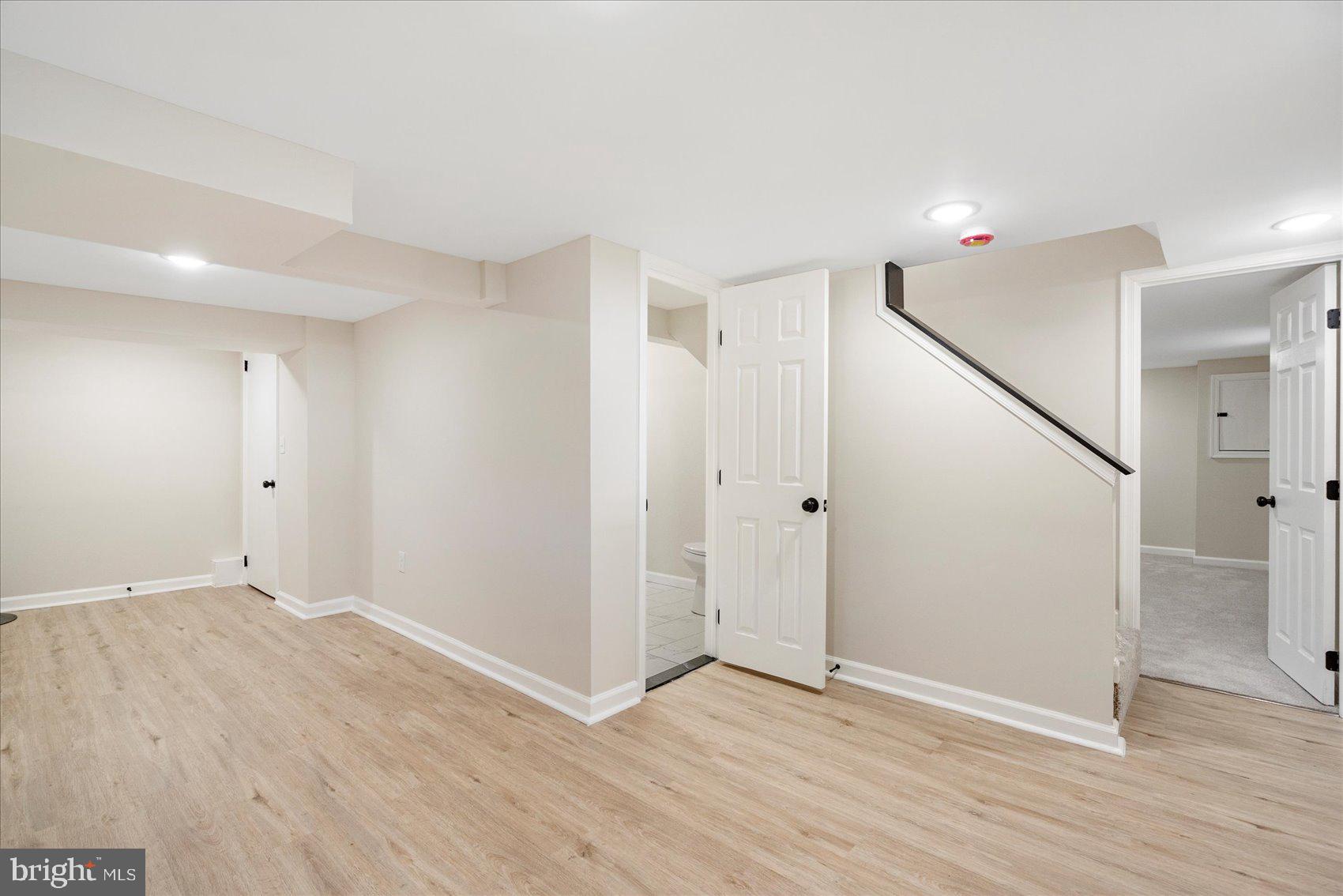 405 Margaret Avenue Baltimore, MD 21221 - Photo 30 of 38 a view of an empty room with wooden floor and stairs