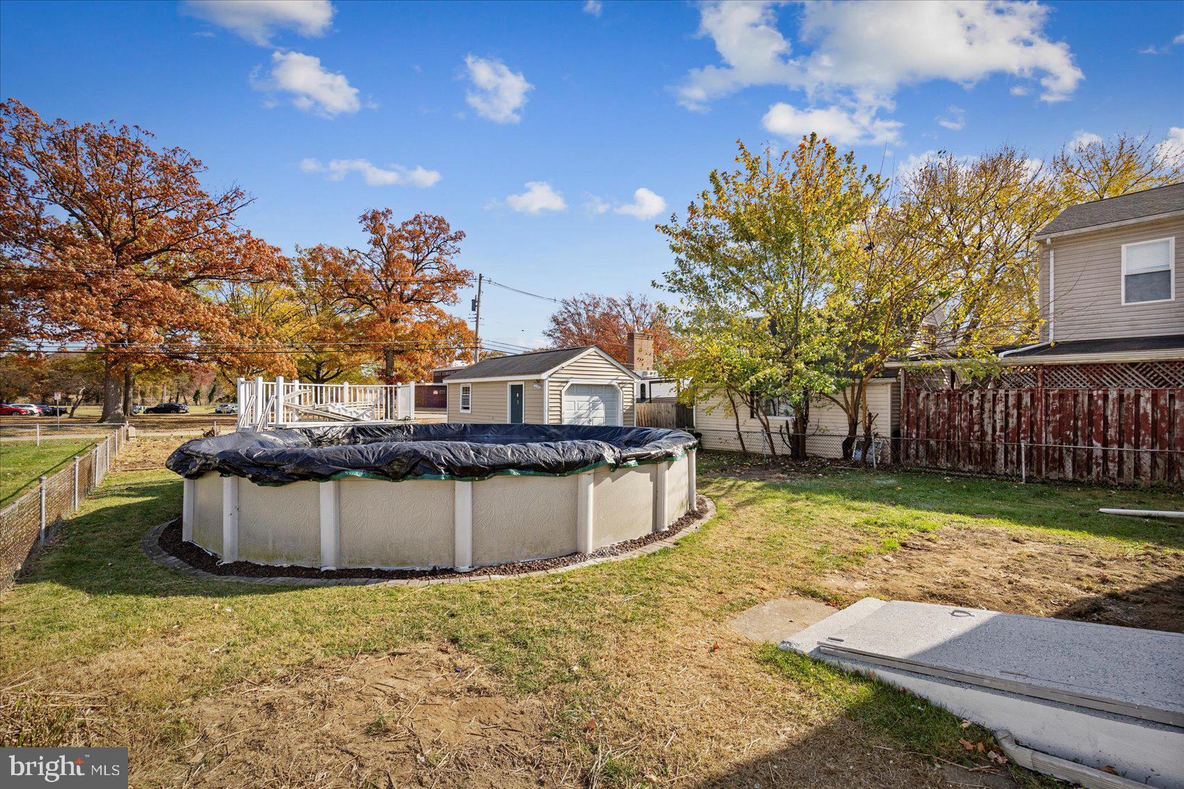 405 Margaret Avenue Baltimore, MD 21221 - Photo 37 of 38 a front view of a house with a garden and tree
