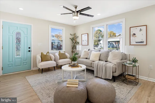 a living room with furniture and wooden floor