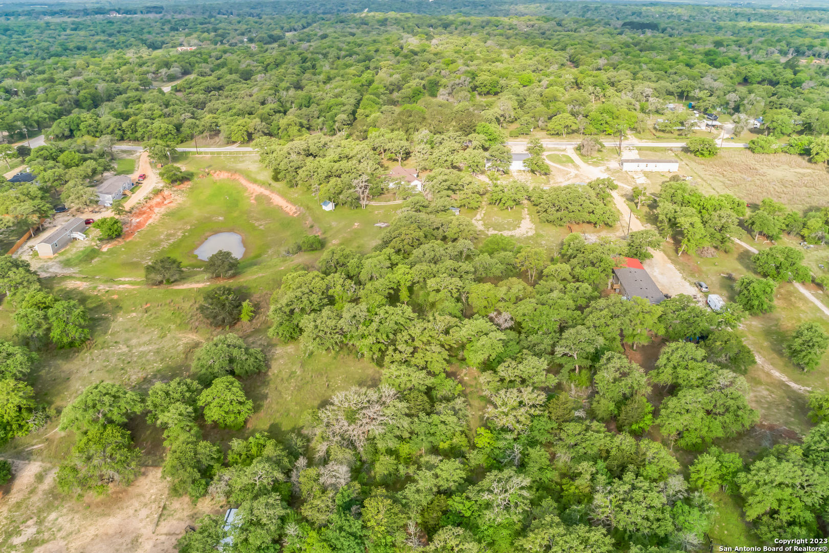 a backyard of a house with large trees