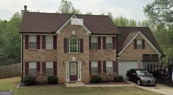 a aerial view of a house with a yard and potted plants