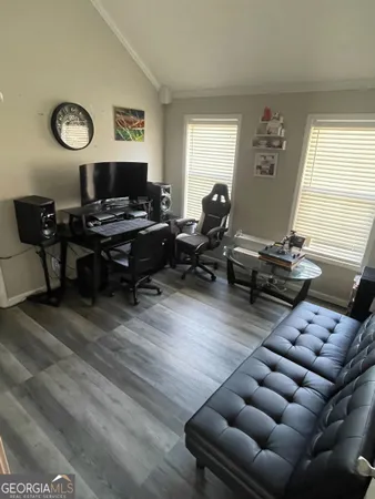 a living room with furniture a rug and a window