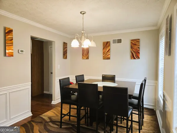 a view of a dining room with furniture and wooden floor