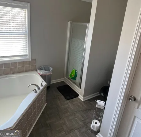 a spacious bathroom with a tub and a shower