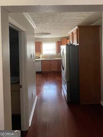 a view of hallway with stairs and wooden floor