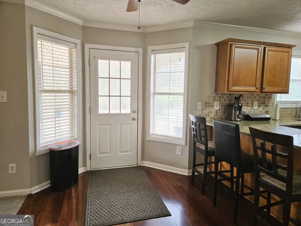a view of a dining room with furniture and window