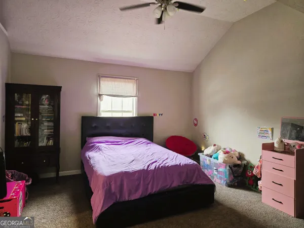 a bedroom with a bed and furniture