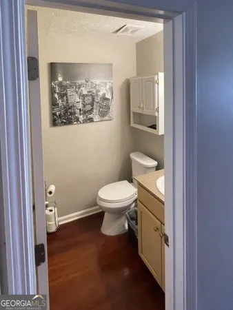 a white toilet sitting next to a bathroom sink