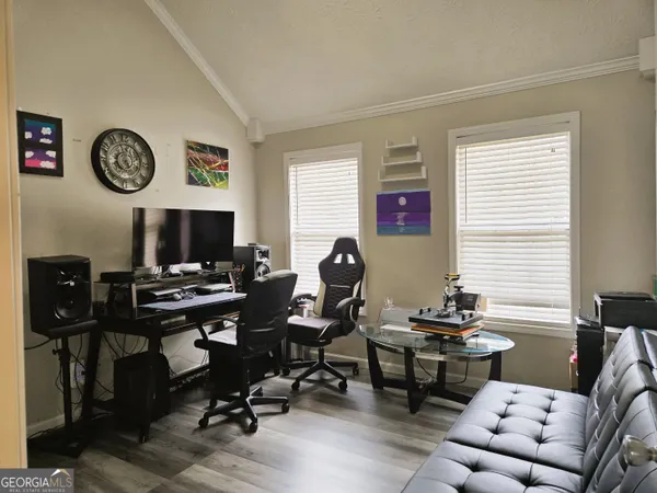 a view of a livingroom with workspace and a couch