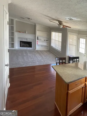 a kitchen with kitchen island a stove and a sink