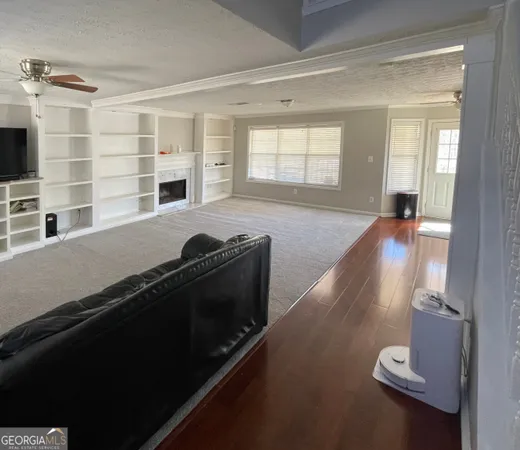 a view of a living room with furniture and a flat screen tv