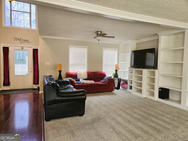 a living room with furniture and a flat screen tv