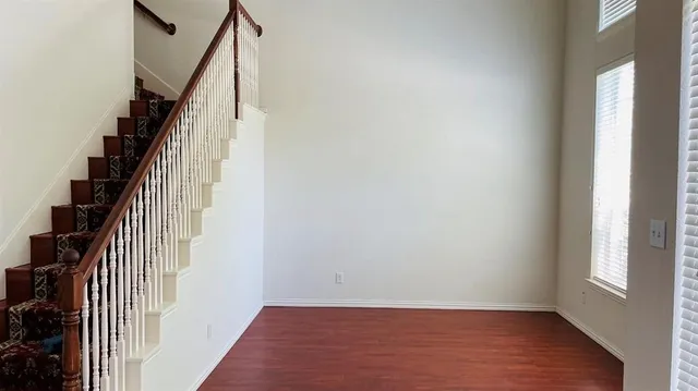 a view of entryway with wooden floor and stairs