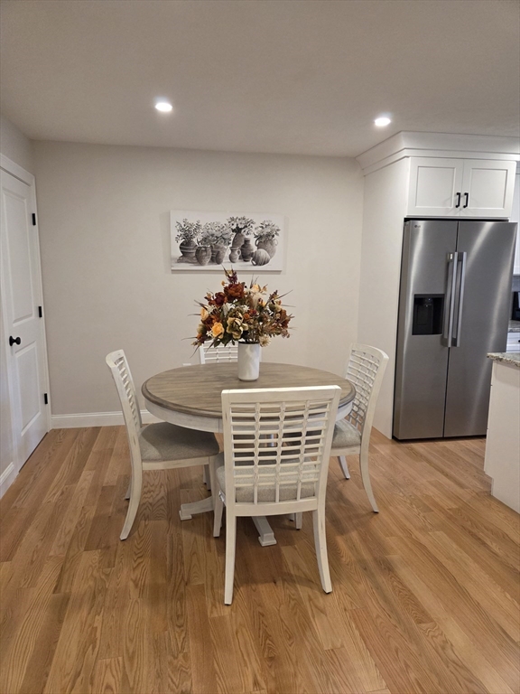 519 Mendon Road, Unit 519 Attleboro, MA 02703 - Photo 4 of 22 a dining room with furniture a rug and wooden floor