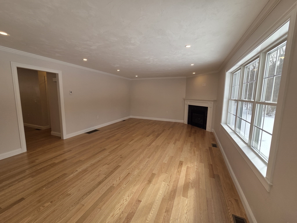 519 Mendon Road, Unit 519 Attleboro, MA 02703 - Photo 8 of 22 wooden floor in an empty room with a window