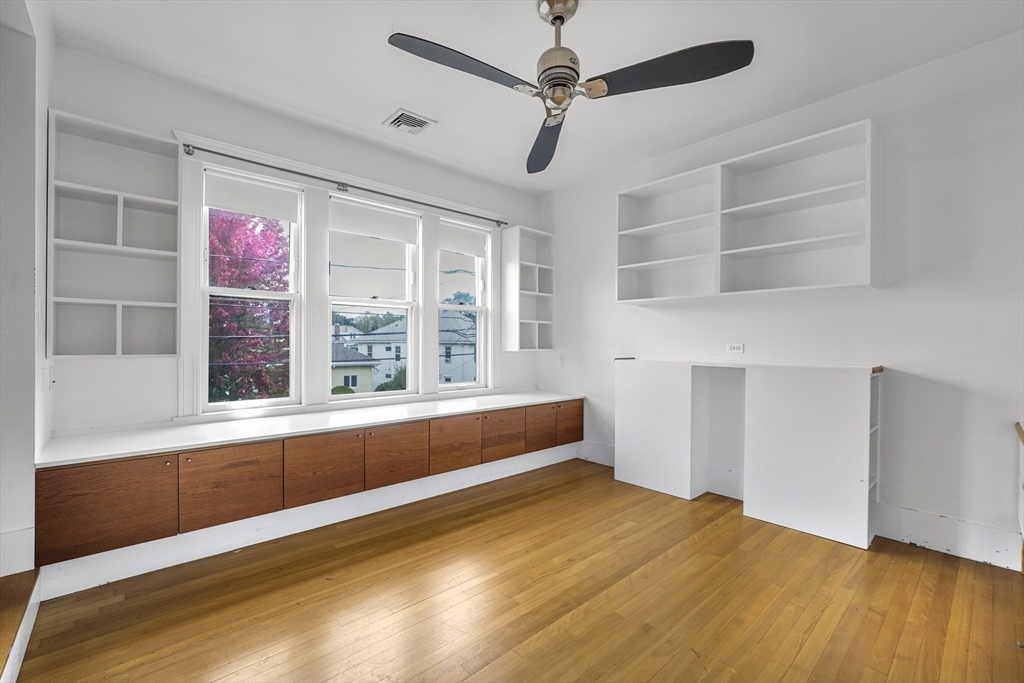 172 Maplewood Street Watertown, MA 02472 - Photo 11 of 42 a view of an empty room with a window and wooden floor
