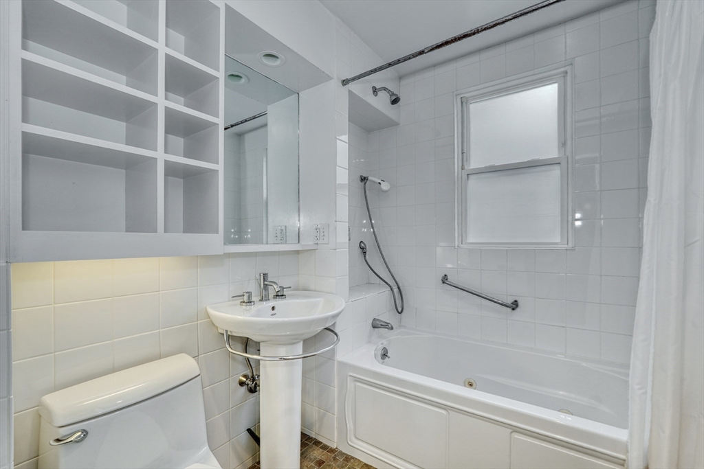 172 Maplewood Street Watertown, MA 02472 - Photo 17 of 42 a bathroom with a sink a toilet and a bathtub