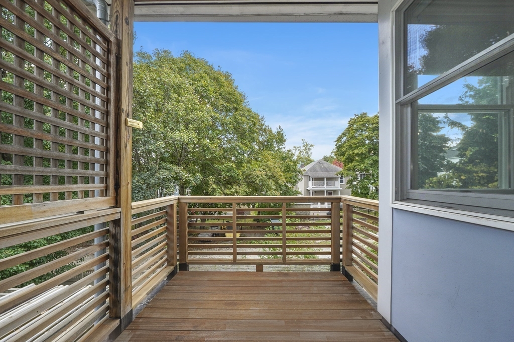 172 Maplewood Street Watertown, MA 02472 - Photo 18 of 42 a view of a balcony with wooden floor and iron stairs