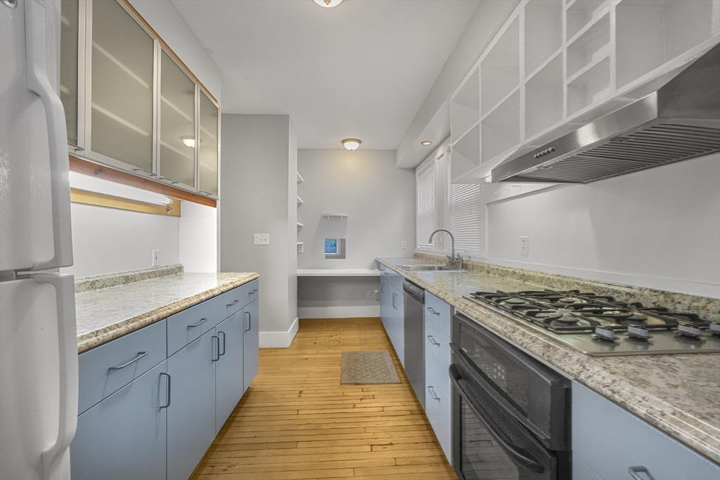 172 Maplewood Street Watertown, MA 02472 - Photo 20 of 42 a large kitchen with stainless steel appliances granite countertop a stove and a sink