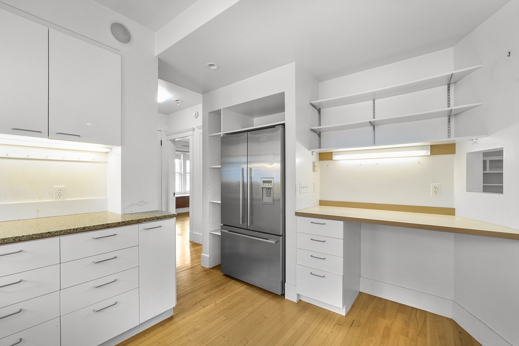 172 Maplewood Street Watertown, MA 02472 - Photo 2 of 42 a kitchen with white cabinets and stainless steel appliances