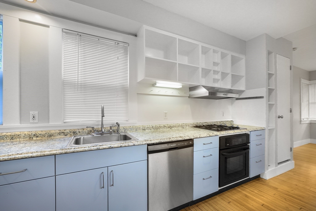 172 Maplewood Street Watertown, MA 02472 - Photo 21 of 42 a kitchen with stainless steel appliances granite countertop a sink stove and cabinets