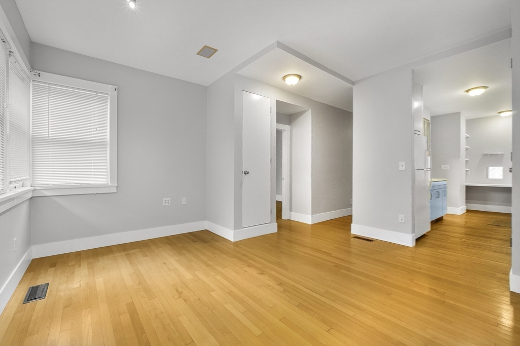 172 Maplewood Street Watertown, MA 02472 - Photo 25 of 42 a view of empty room with wooden floor and windows