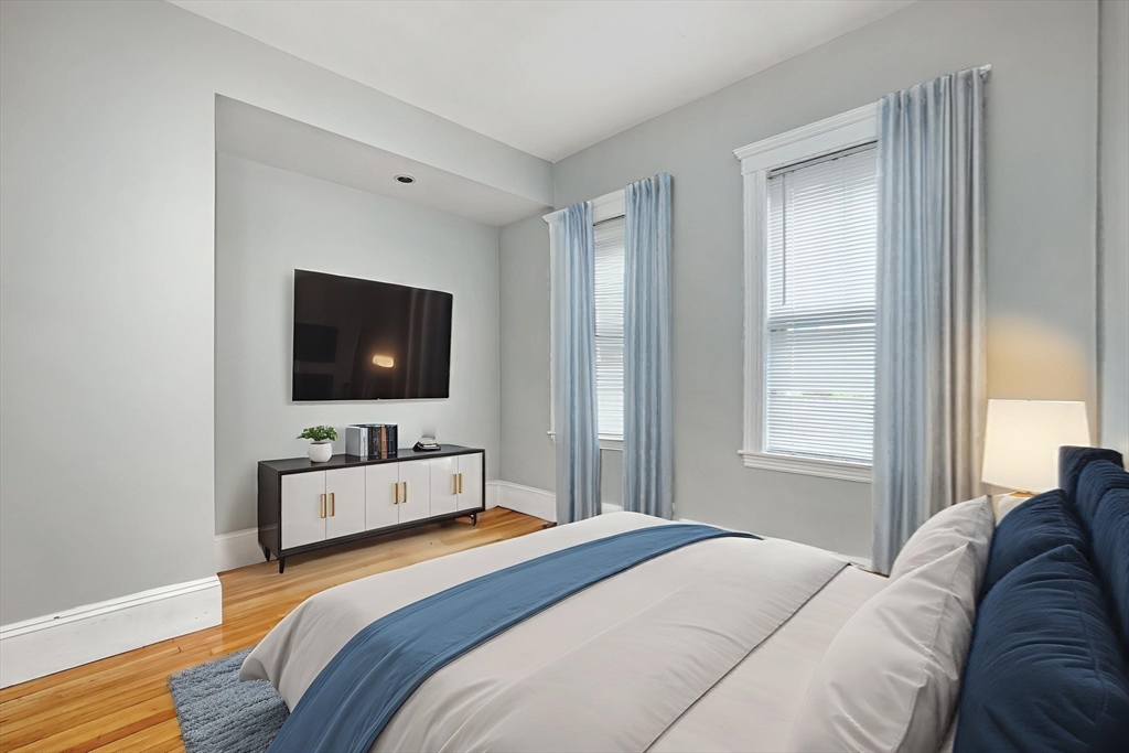 172 Maplewood Street Watertown, MA 02472 - Photo 27 of 42 a bedroom with a bed and a flat screen tv