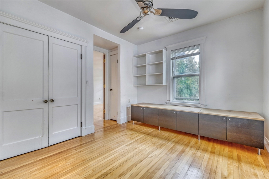 172 Maplewood Street Watertown, MA 02472 - Photo 8 of 42 a view of an empty room with a window and wooden floor