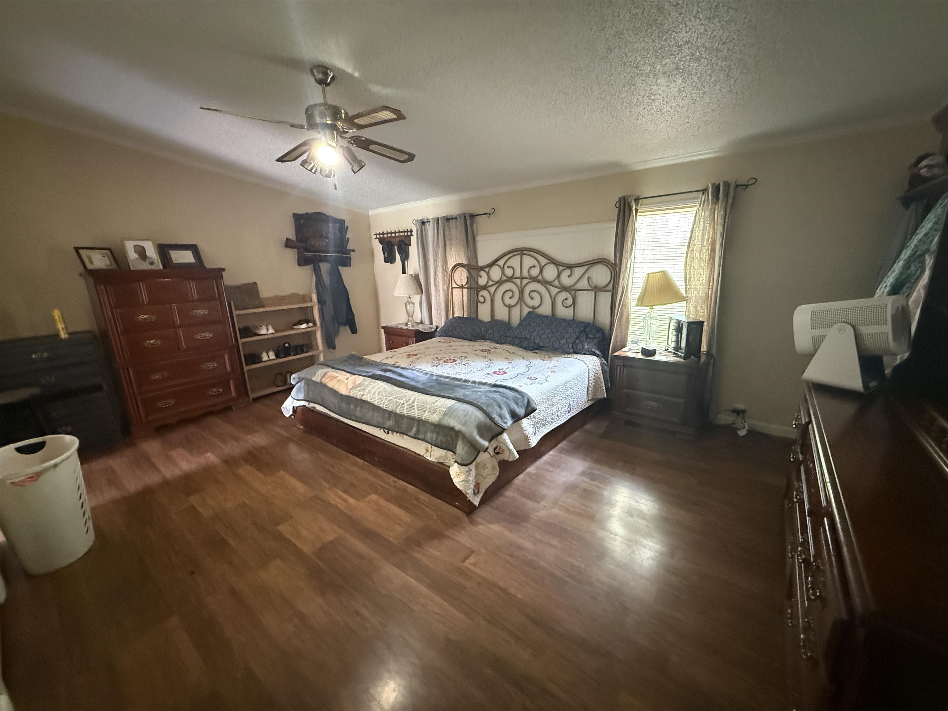 2201 Robert Johnson Road Covington, TN 38019 - Photo 17 of 25 Spacious room featuring wood-finish flooring, a ceiling fan, and crown molding
