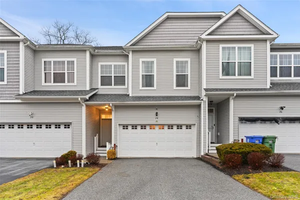 a front view of a house with many windows