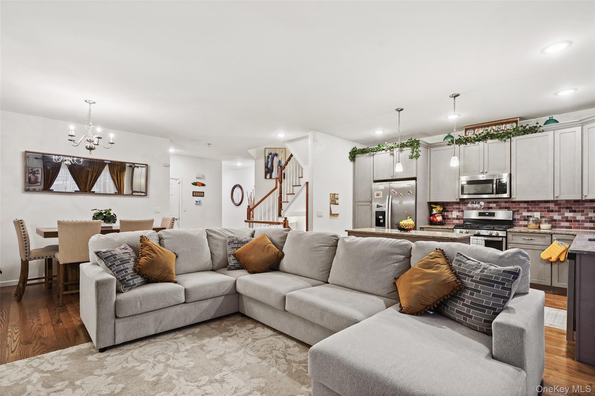 28 Magnolia Pk Road Middletown, NY 10940 - Photo 8 of 25 a living room with furniture kitchen view and a chandelier