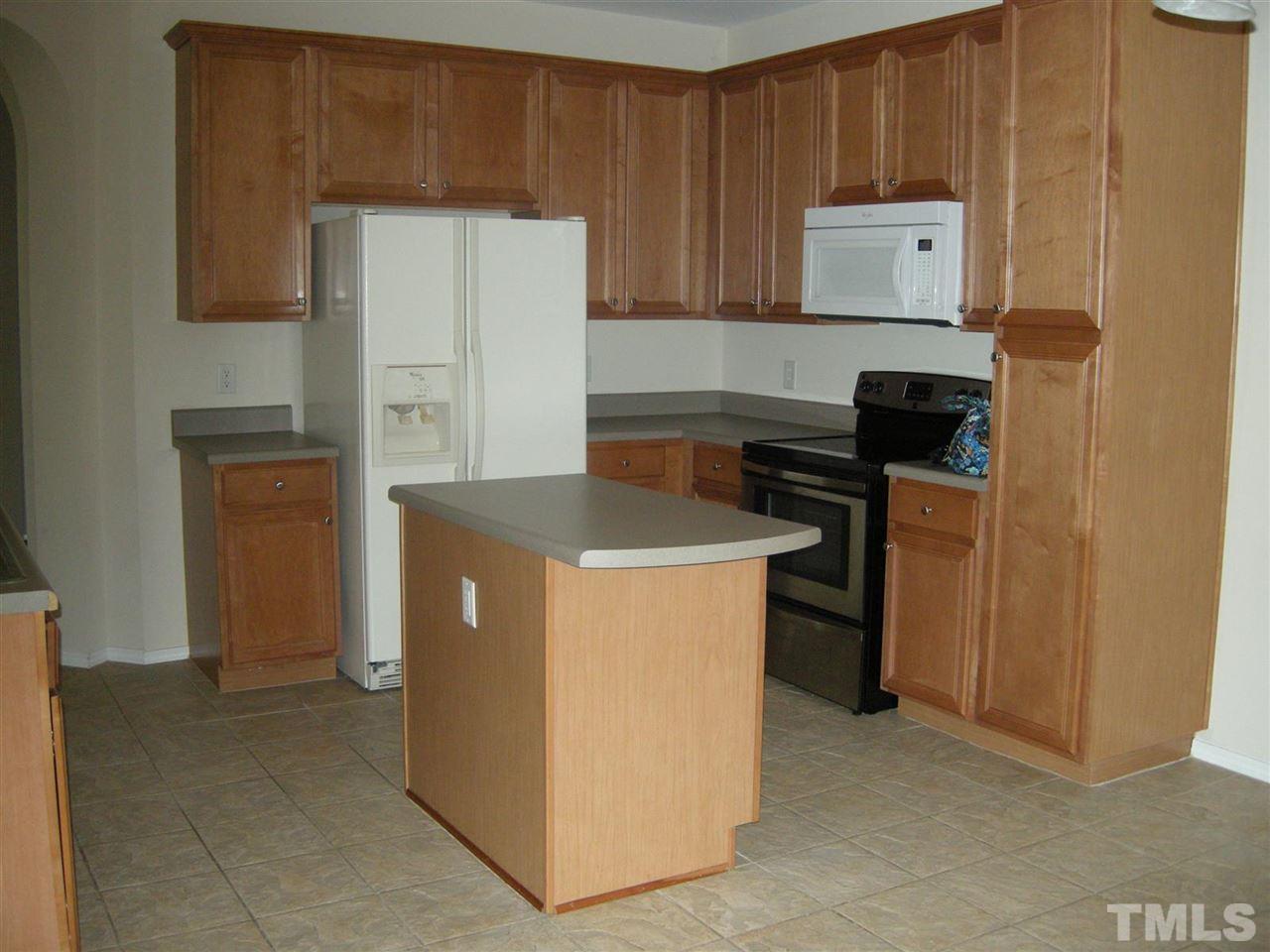 8423 Header Stone Drive Raleigh, NC 27613 - Photo 3 of 14 a utility room with refrigerator stove and a refrigerator