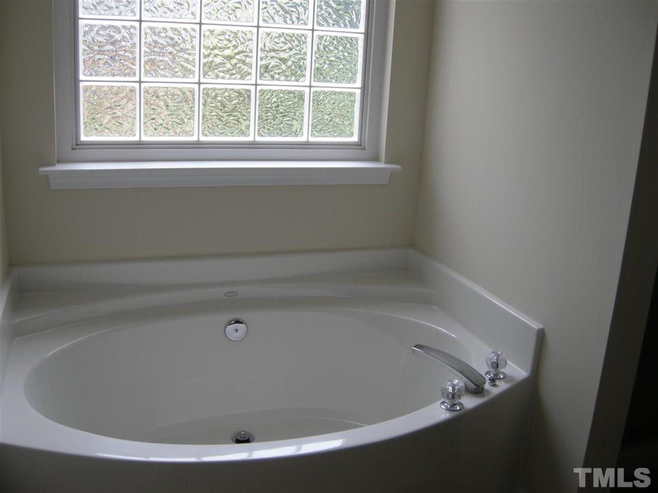 8423 Header Stone Drive Raleigh, NC 27613 - Photo 10 of 14 a view of a bathtub in a bathroom
