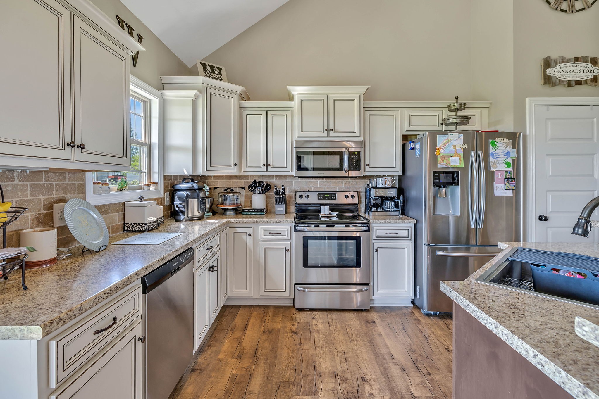 8087 Dunn Road Cedar Hill, TN 37032 - Photo 11 of 33 a kitchen with stainless steel appliances granite countertop a sink stove and refrigerator