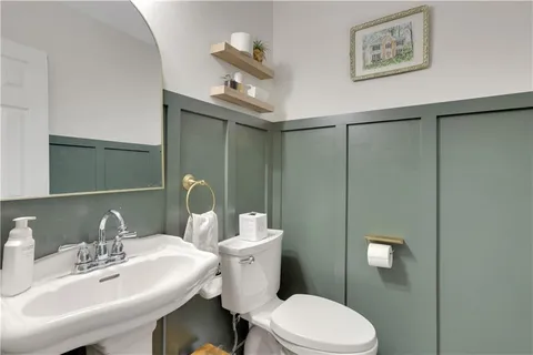 a spacious bedroom with a bed and a flat screen tv