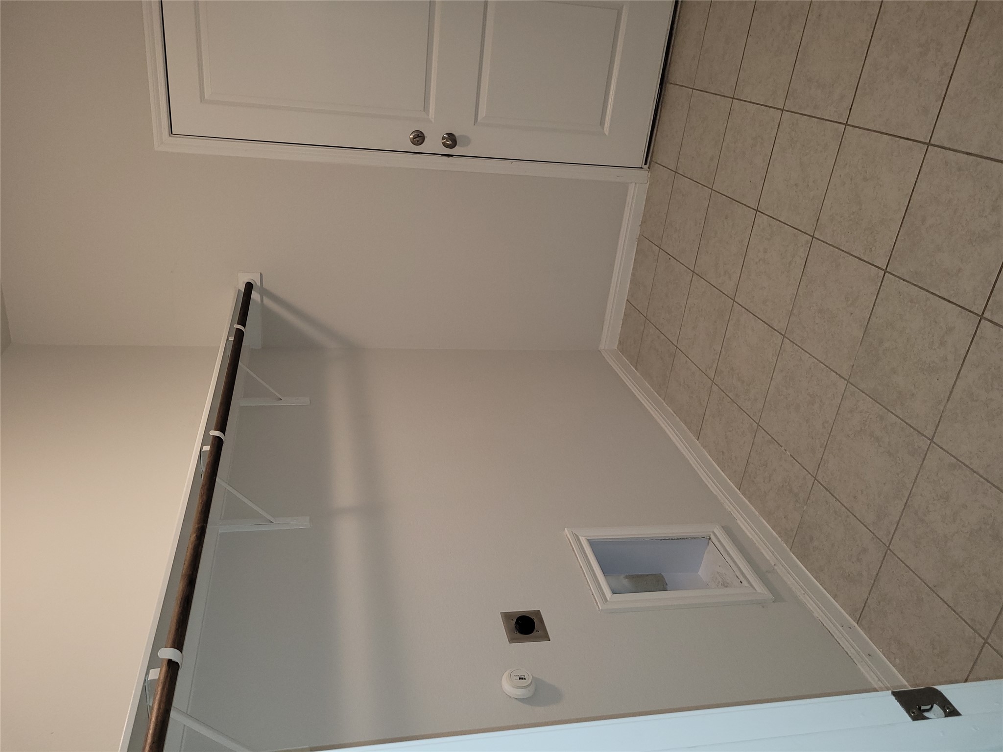 8308 Daisy Cutter Crossing Georgetown, TX 78626 - Photo 23 of 27 Functional laundry space featuring tiled flooring and a convenient storage shelf.