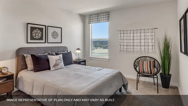 a bedroom with a bed a dresser and a window