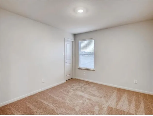 a view of an empty room and a window