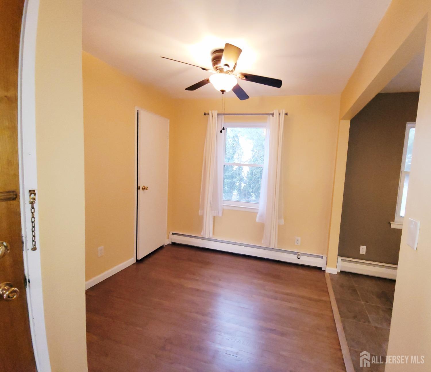 50 Fox Road, Unit 8B Edison, NJ 08817 - Photo 14 of 35 a view of an empty room with wooden floor and a window