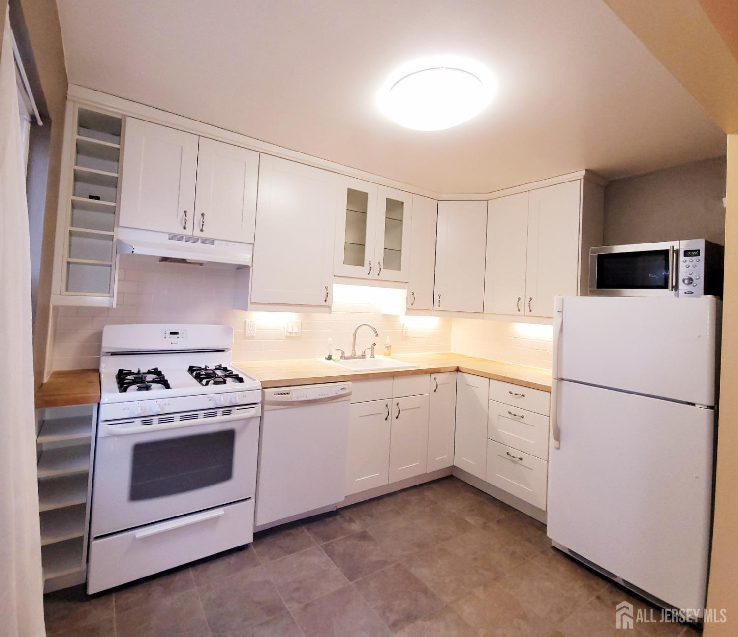 50 Fox Road, Unit 8B Edison, NJ 08817 - Photo 17 of 35 a kitchen with cabinets appliances and a sink