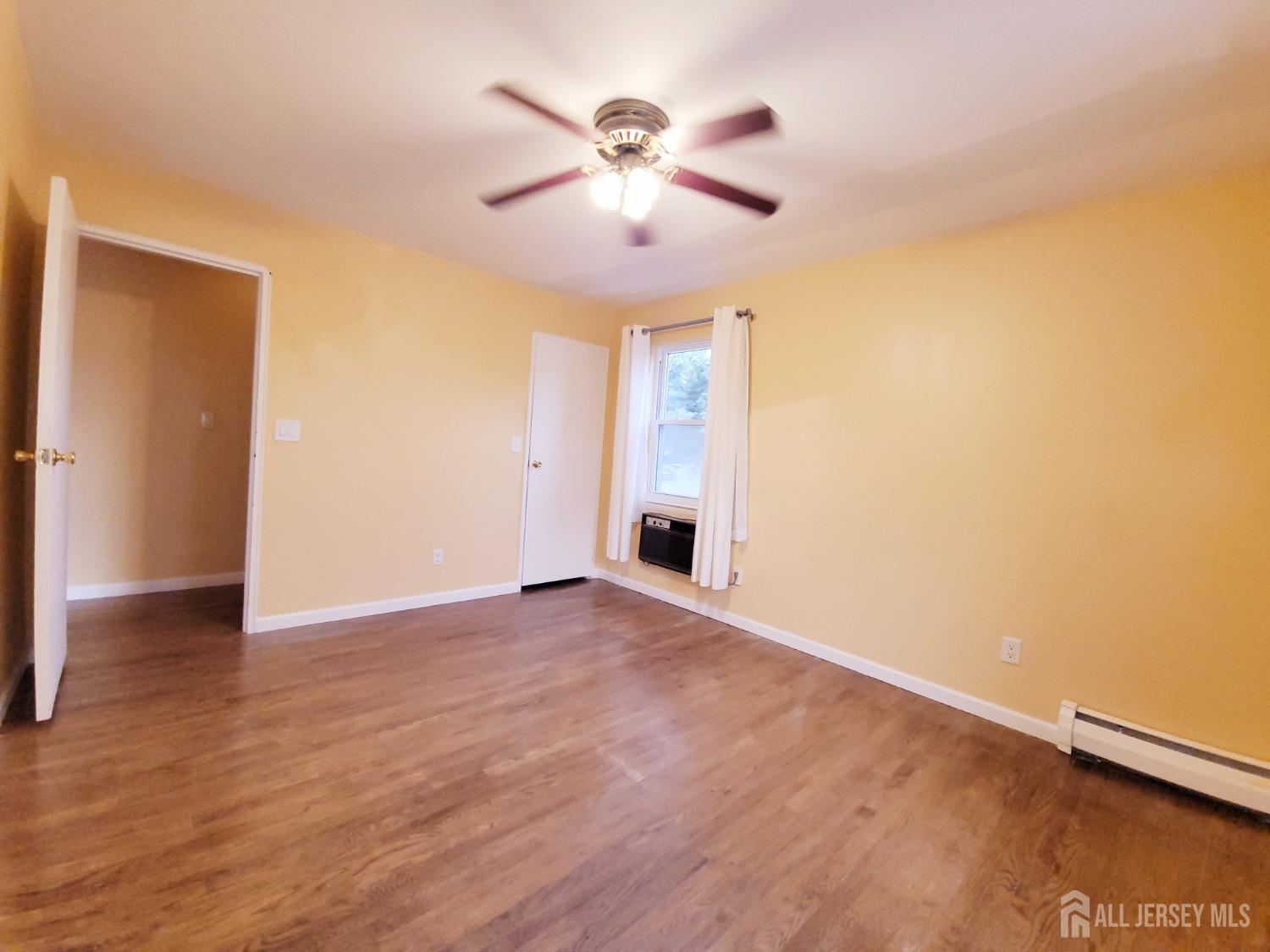 50 Fox Road, Unit 8B Edison, NJ 08817 - Photo 20 of 35 a view of an empty room with wooden floor