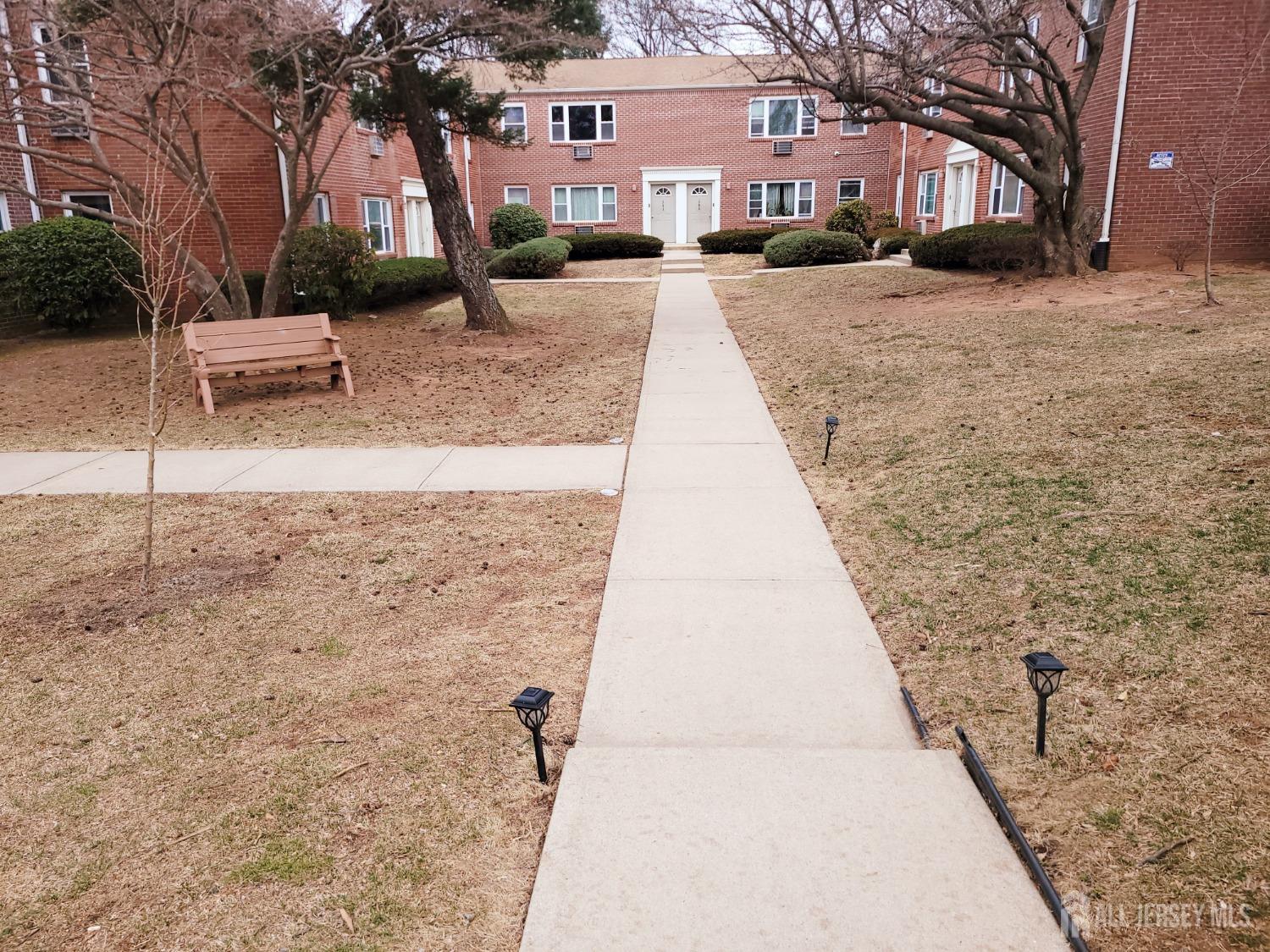 50 Fox Road, Unit 8B Edison, NJ 08817 - Photo 2 of 35 a pathway of a house with a yard covered in snow