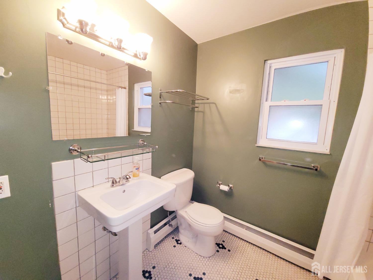 50 Fox Road, Unit 8B Edison, NJ 08817 - Photo 29 of 35 a bathroom with a sink toilet and mirror