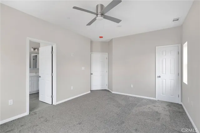 a view of a livingroom with a ceiling fan & a ceiling fan