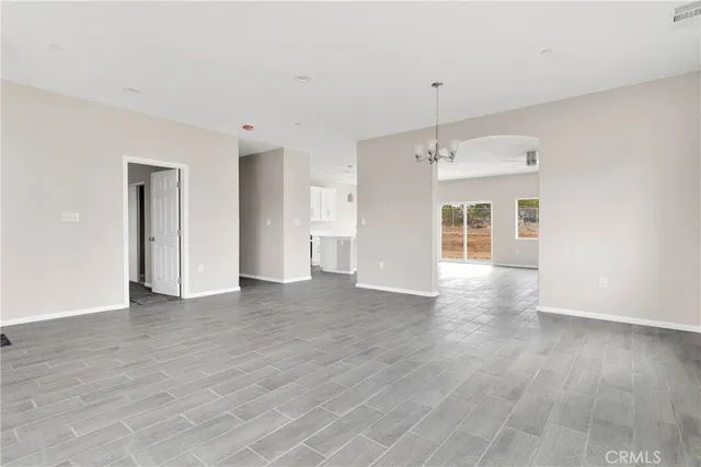 a view of a livingroom with wooden floor and a ceiling fan